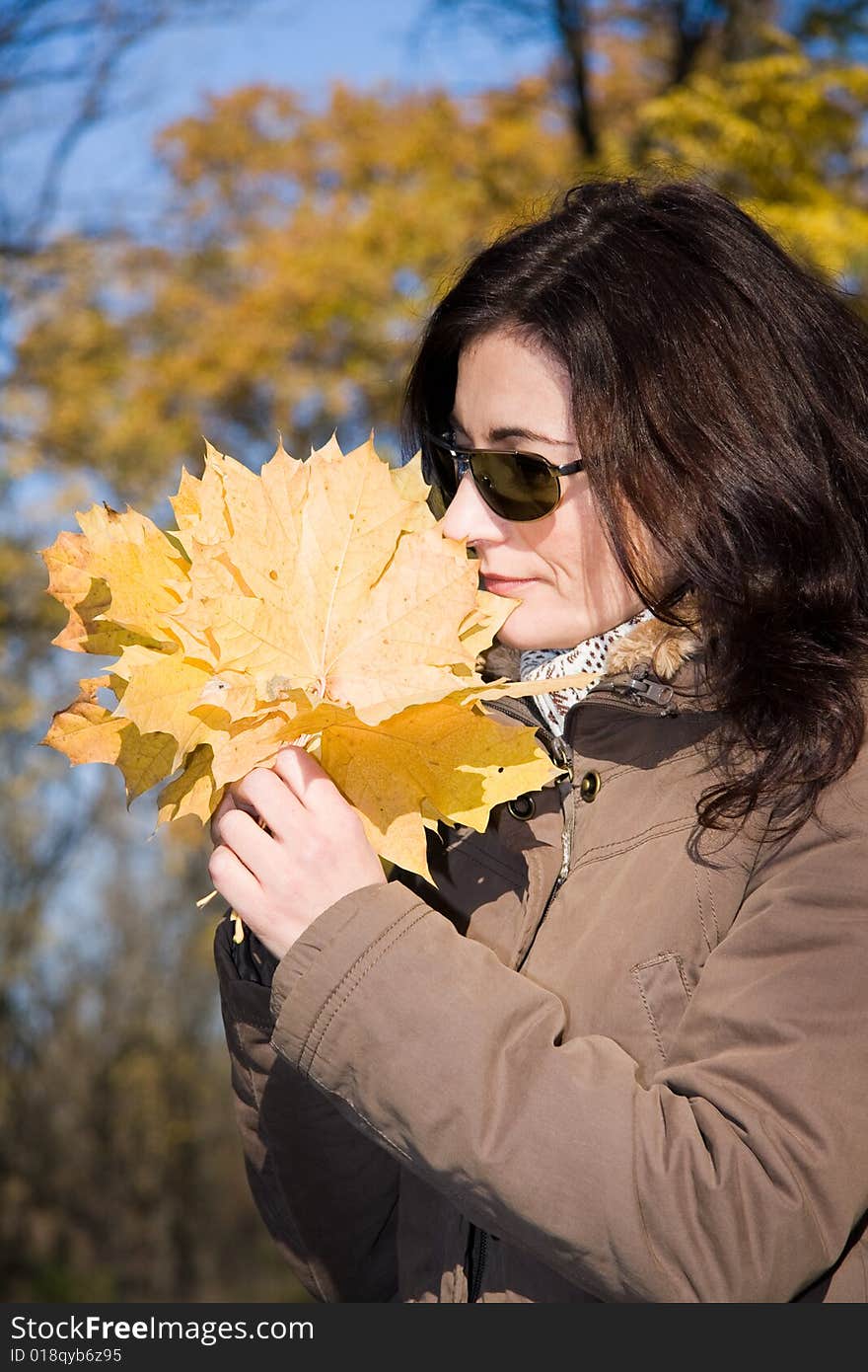 Woman with yellow leaves in autumn forest. Woman with yellow leaves in autumn forest