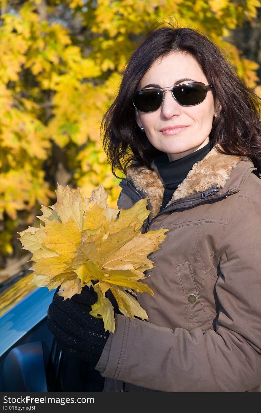 Woman with yellow leaves in autumn forest. Woman with yellow leaves in autumn forest