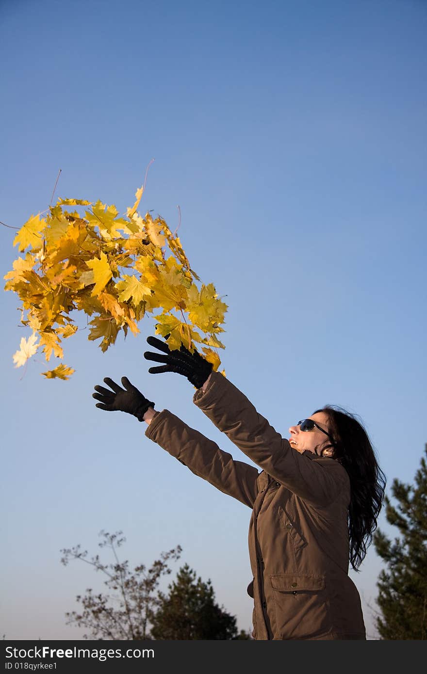 Woman with yellow leaves in autumn forest. Woman with yellow leaves in autumn forest