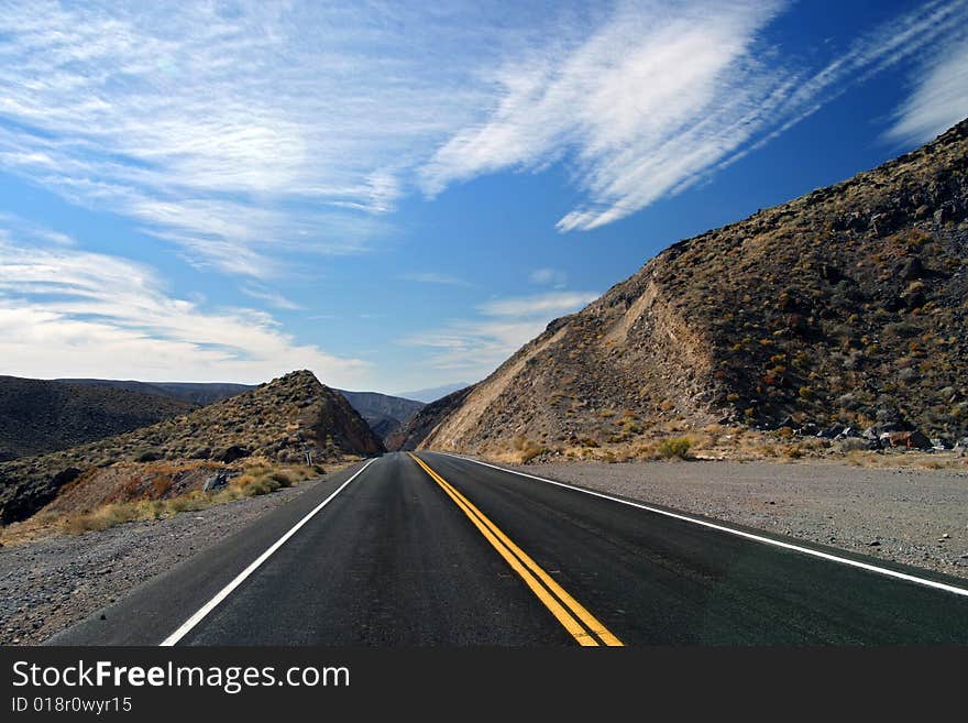 Barren desert road with clouds and sky. Barren desert road with clouds and sky