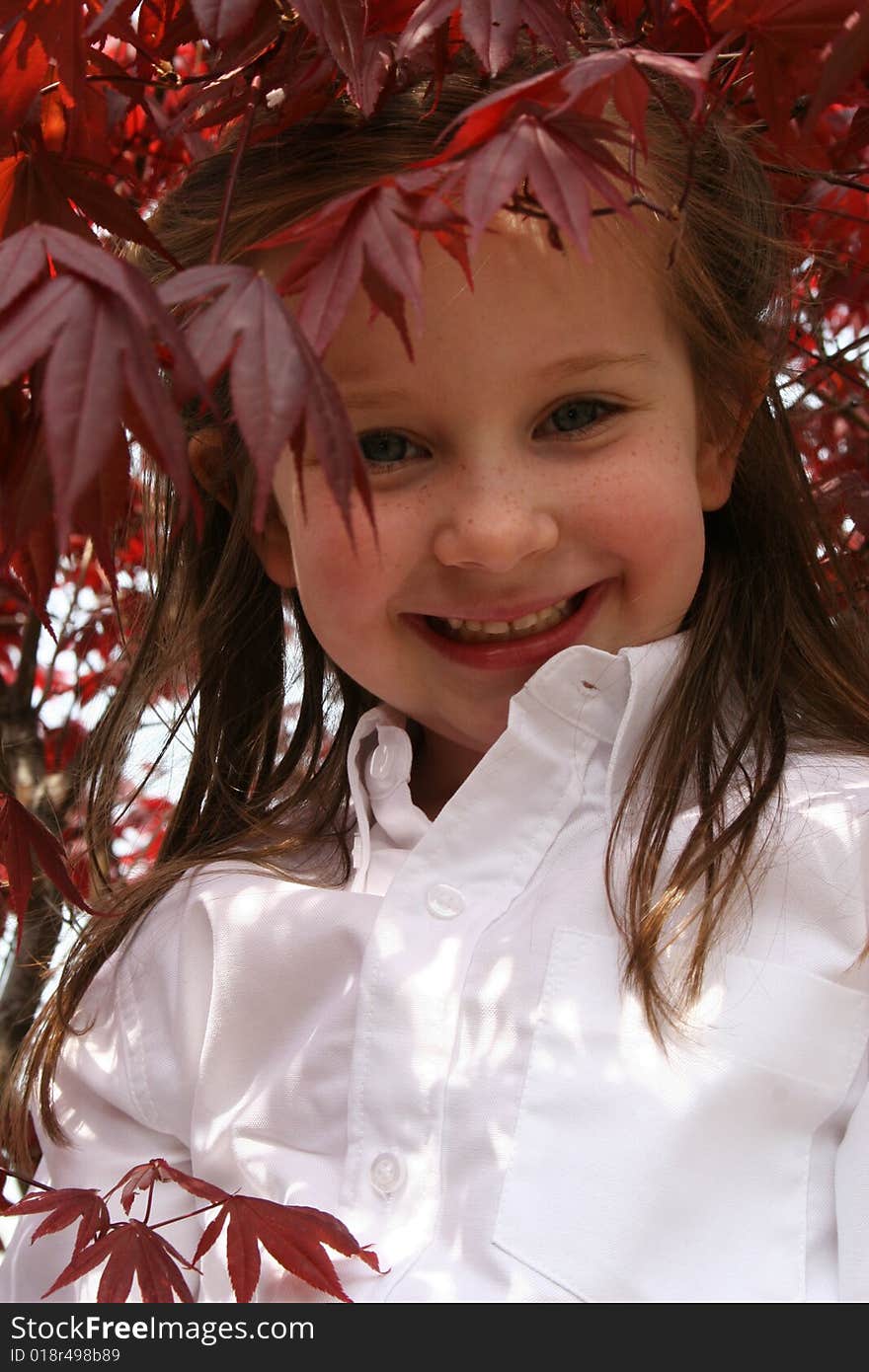 Little girl stands under a tree. Little girl stands under a tree