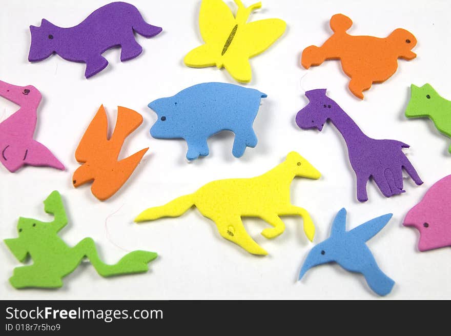 A photograph of colorful animals against a white background. A photograph of colorful animals against a white background