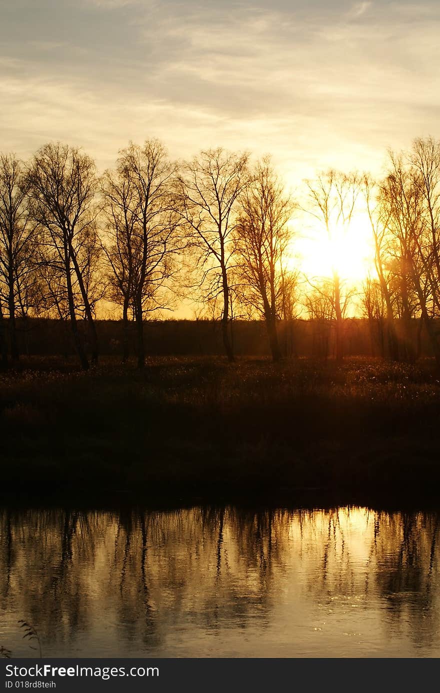 Autumn sunset at the river with reflections on water. Autumn sunset at the river with reflections on water