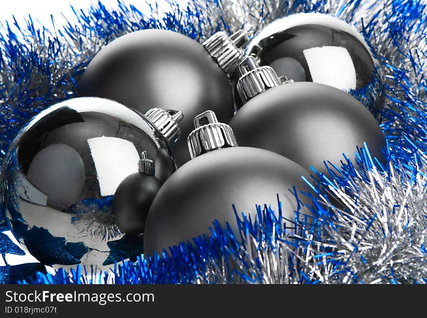 Dark balls on silver tinsel. Dark balls on silver tinsel