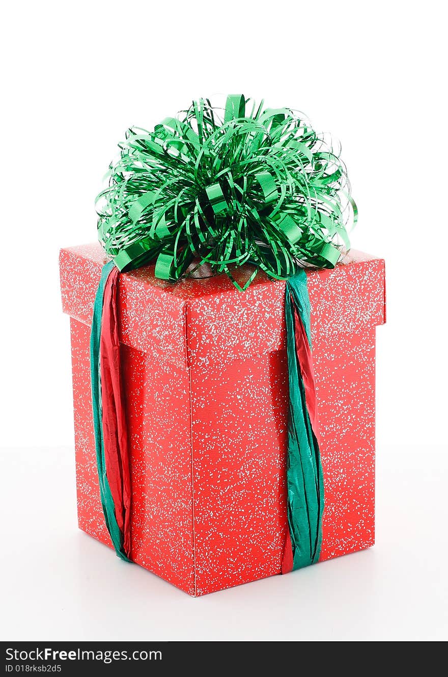 Red gift box with green decoraion on white background