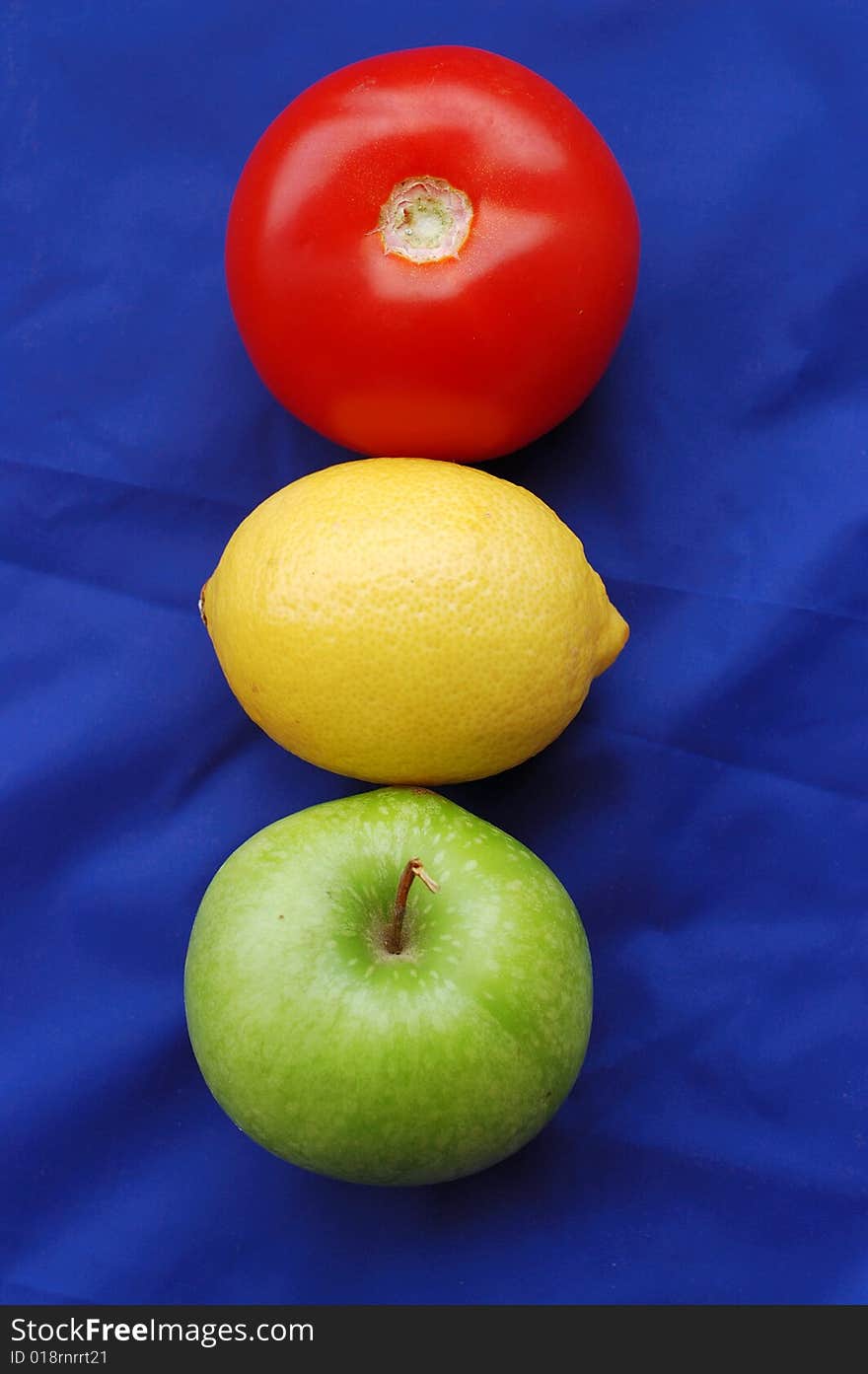 Concept of fruits representing traffic light on blue background. Concept of fruits representing traffic light on blue background