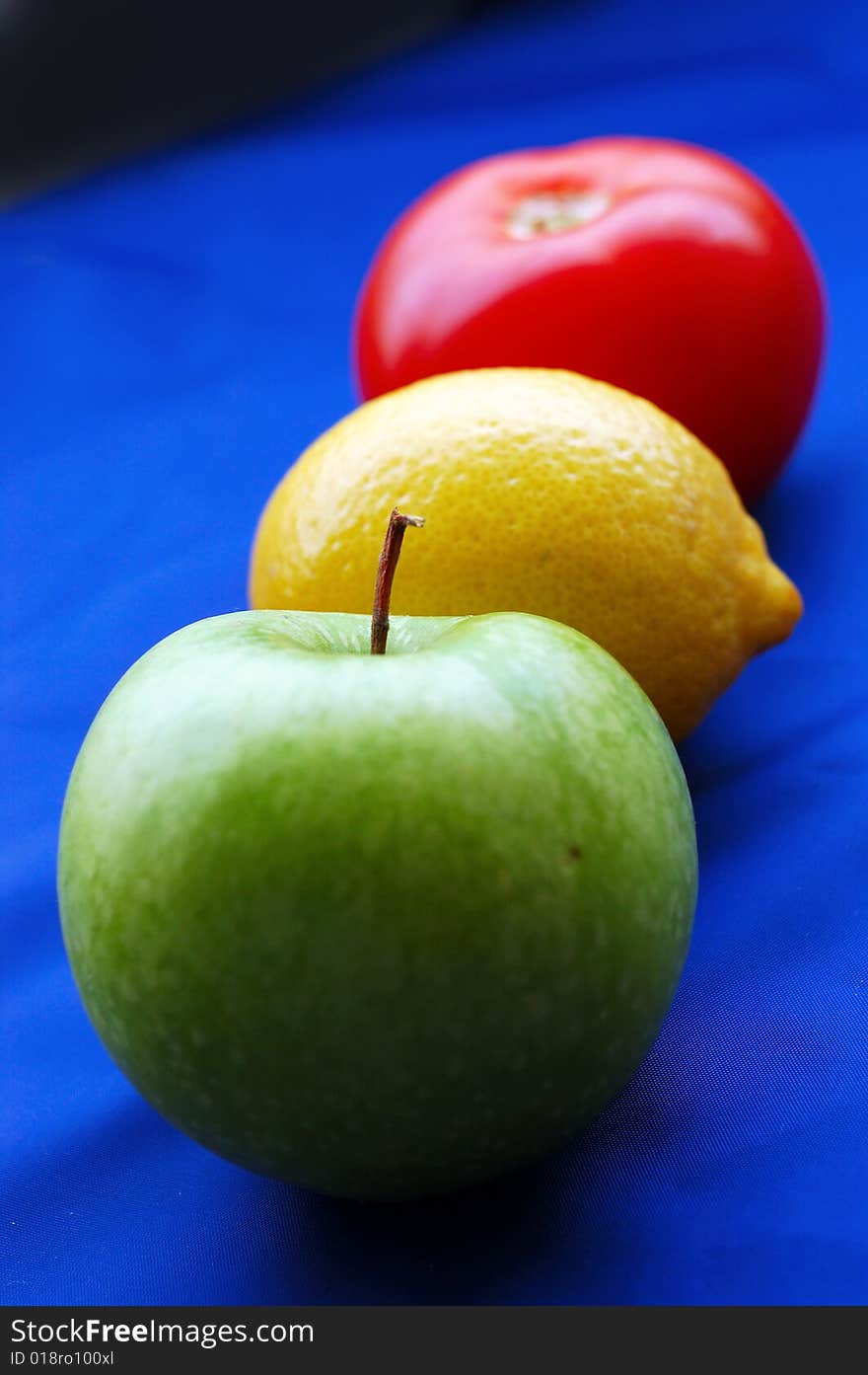 Concept of fruits representing traffic light on blue background (perspective with thin depth of field). Concept of fruits representing traffic light on blue background (perspective with thin depth of field)