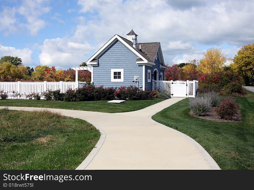 Blue Pool House with White Trim