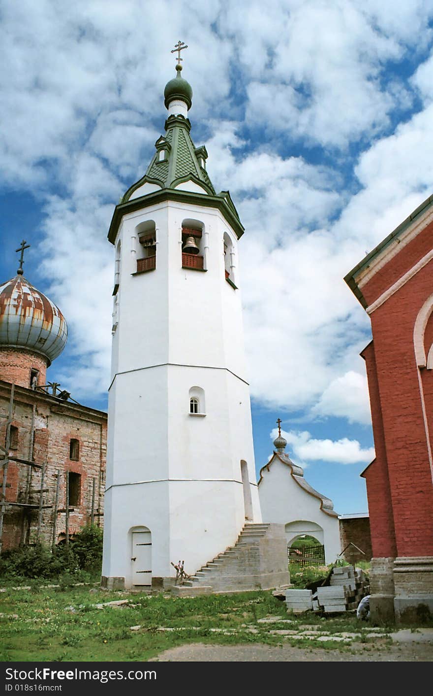 White bell tower in renovated monastery