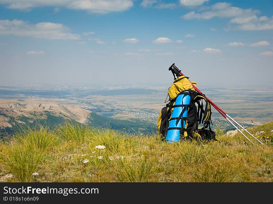 Summer mountain landscape with backpack in foreground. Summer mountain landscape with backpack in foreground