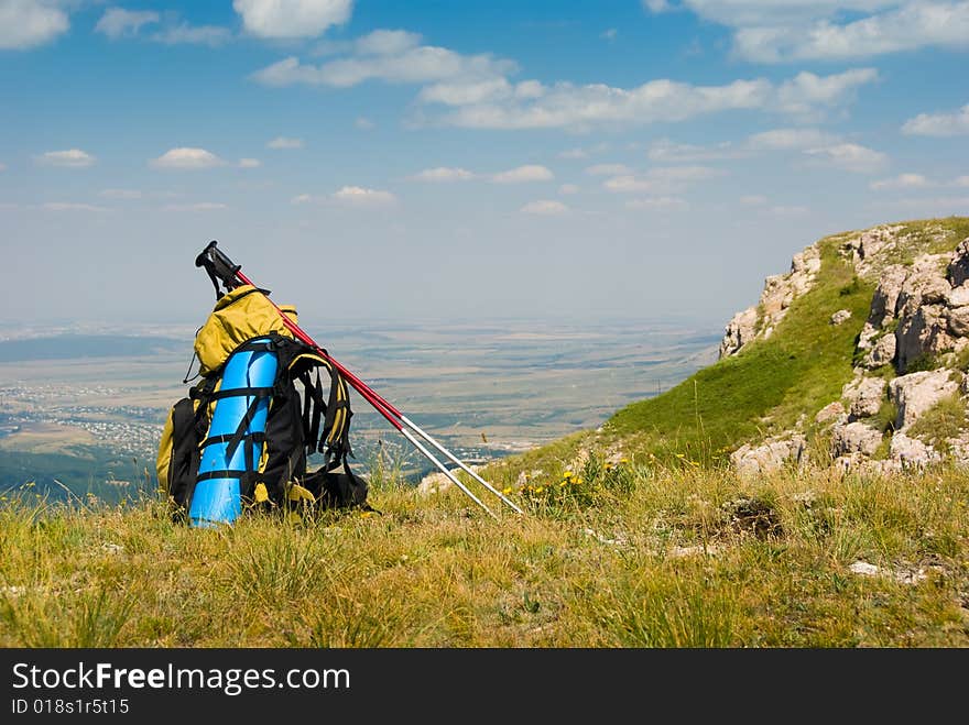 Summer mountain landscape with backpack in foreground. Summer mountain landscape with backpack in foreground