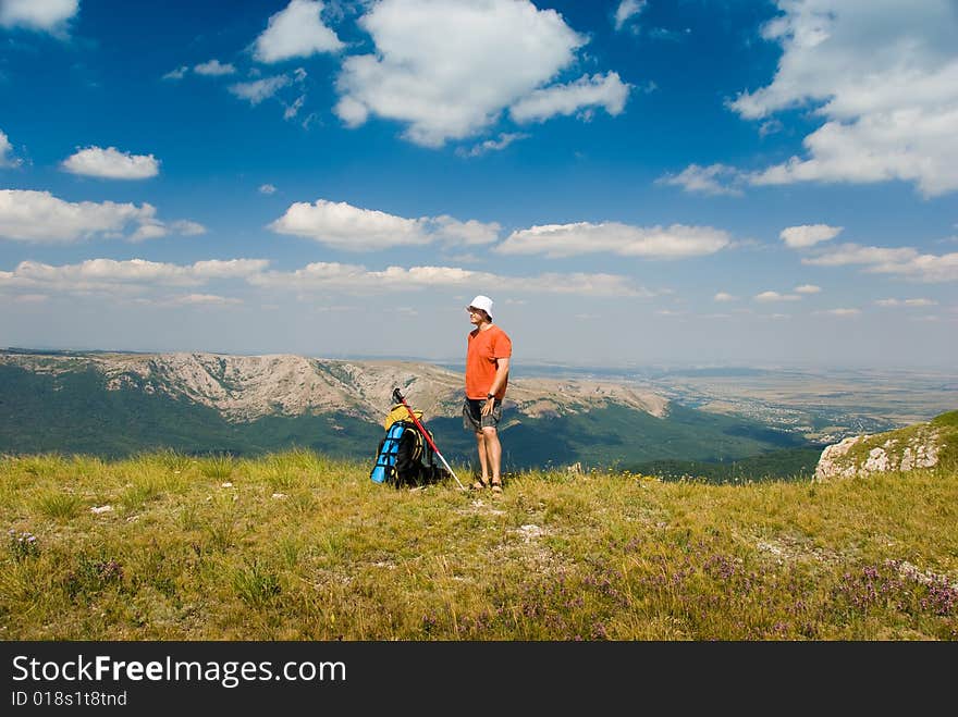 Happy hiker in mountains, beautiful landscape in background