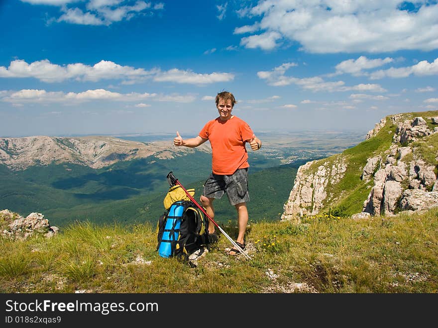 Happy hiker in mountains, beautiful landscape in background