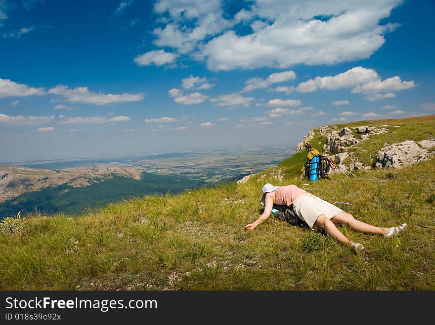 Happy all-in hiker relaxes in mountains. Happy all-in hiker relaxes in mountains