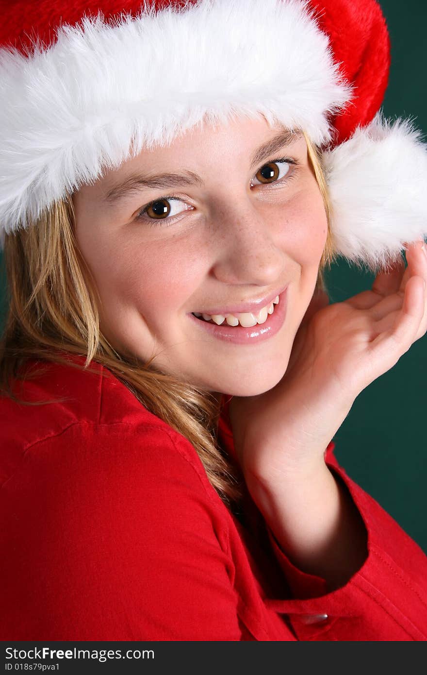 Beautiful teenager wearing a red shirt and christmas hat. Beautiful teenager wearing a red shirt and christmas hat