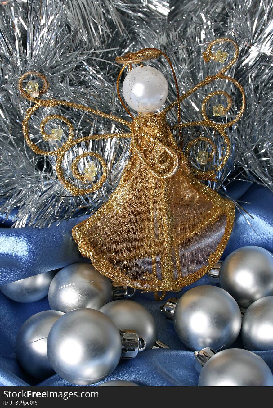 Golden Christmas Angel amongst other silver decorations