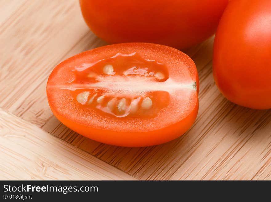 Cut tomatoes on chopping board.