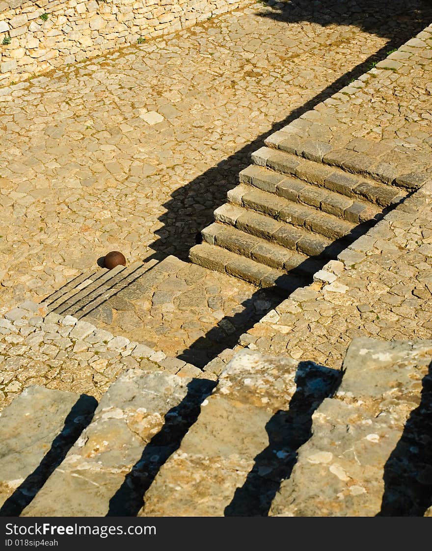 Geometric composition of steps at the Nafplio fortress, Castle Palamidi. Single canon ball at foot of the bottom step. Geometric composition of steps at the Nafplio fortress, Castle Palamidi. Single canon ball at foot of the bottom step.