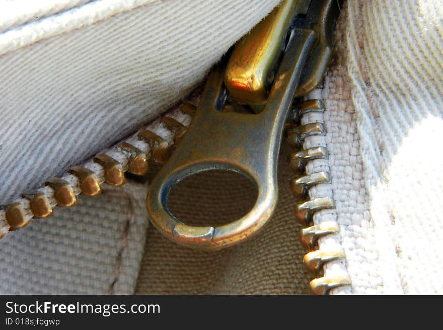 A macro closeup shot of a zipper and heavy weave cotton. A macro closeup shot of a zipper and heavy weave cotton