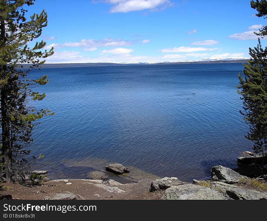 Huge volcanic lake with blue sky and white clouds. Huge volcanic lake with blue sky and white clouds.