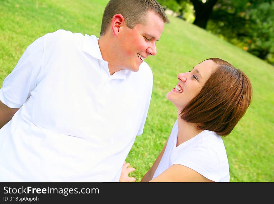 Happy couple embracing and playing in the park. concept for family and young people. Happy couple embracing and playing in the park. concept for family and young people