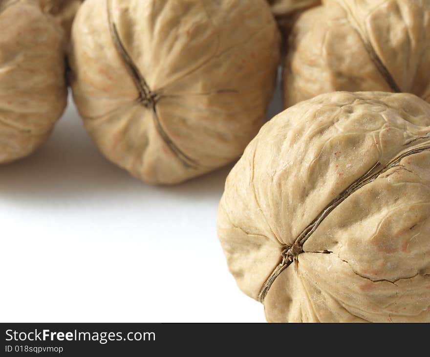 Close-up of a walnut with walnuts as a background. Close-up of a walnut with walnuts as a background.