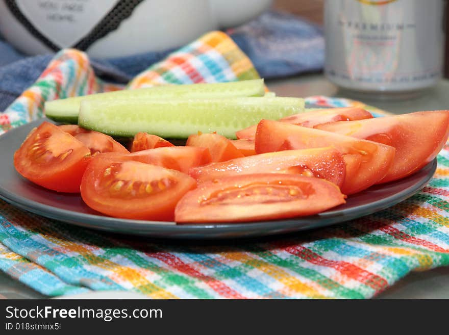 Cucumbers, tomatoes cut slices on a plate. Cucumbers, tomatoes cut slices on a plate