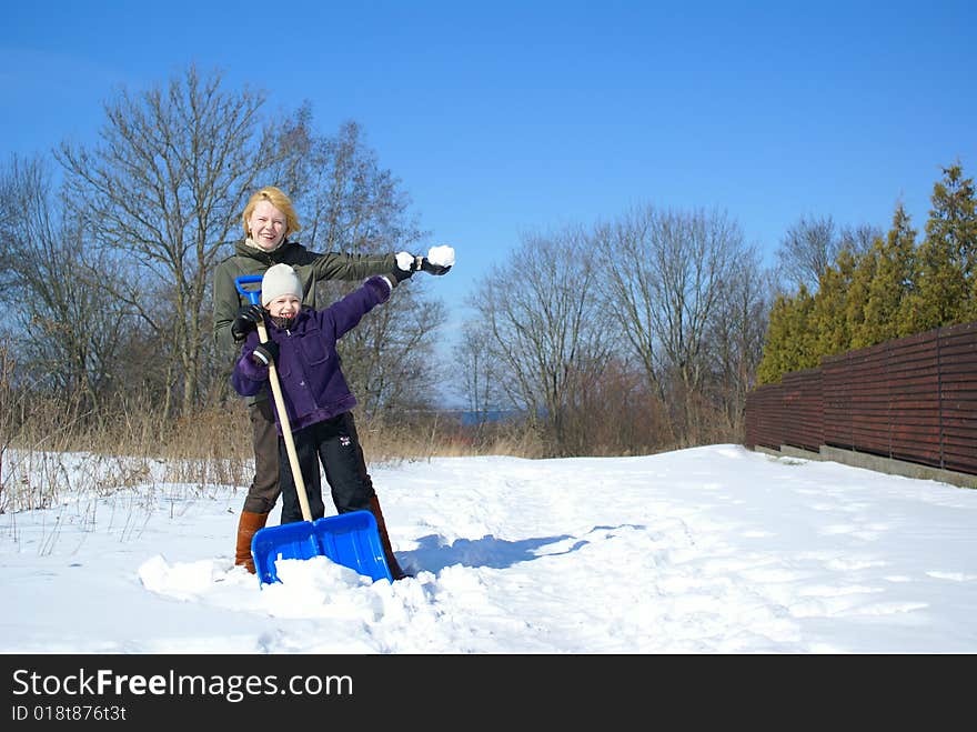 Mother and her daughter on a winter background