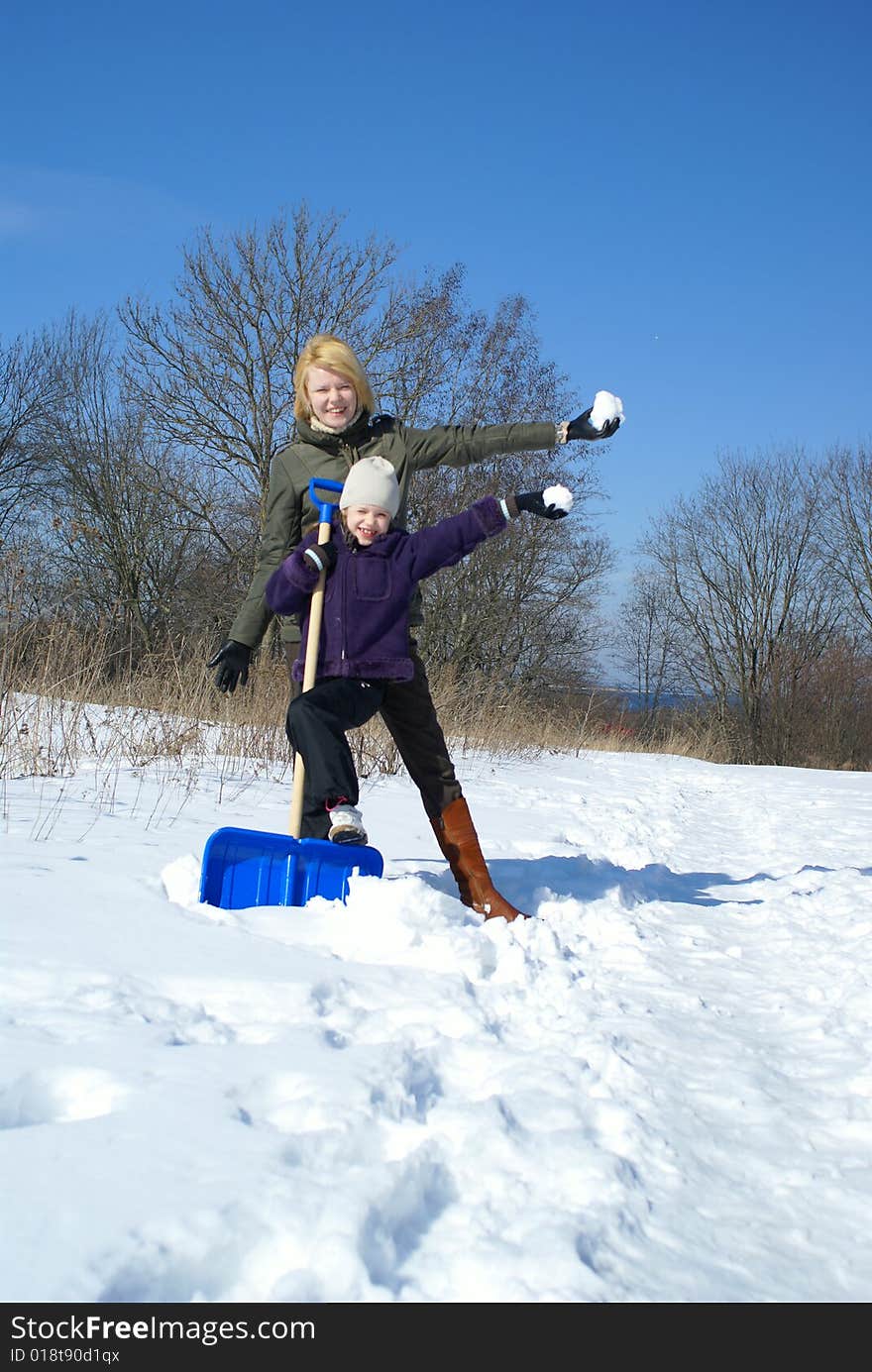 Mother and her daughter on a winter background