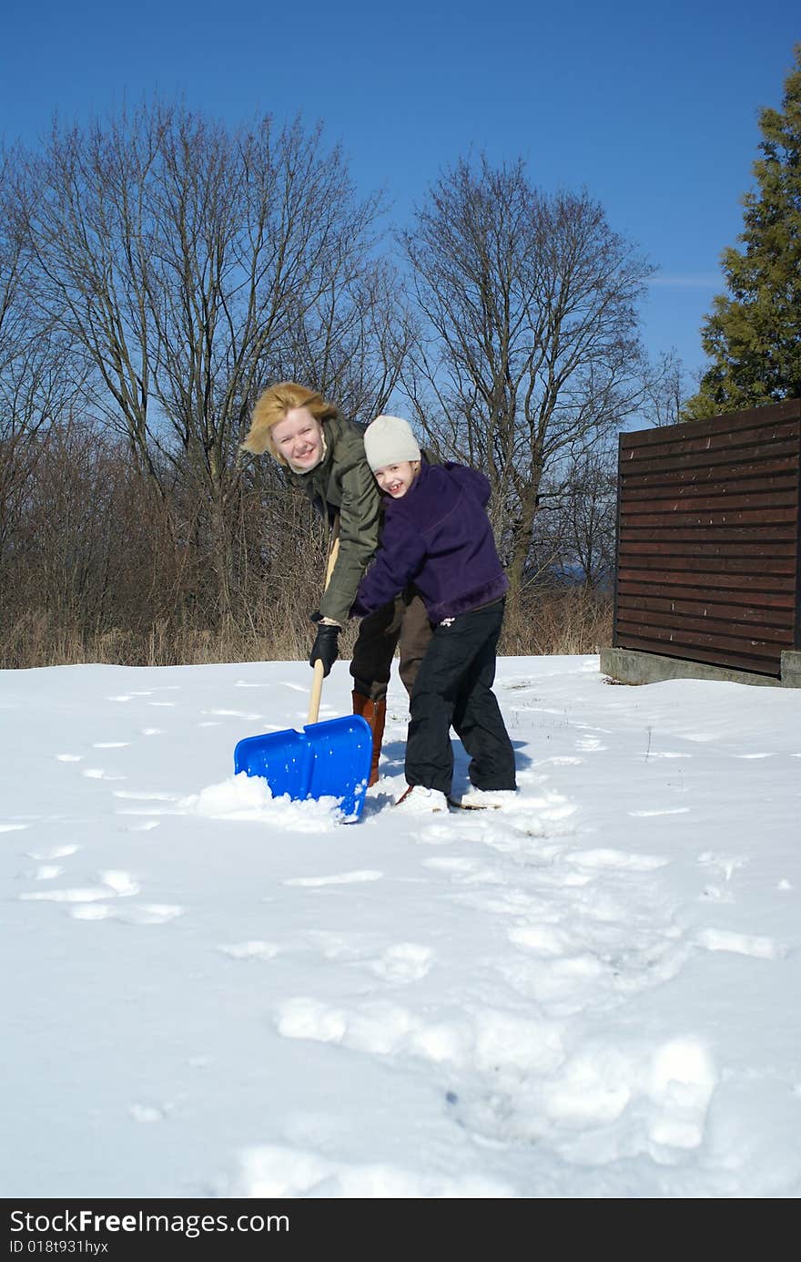 Mother and her daughter throw up snow on a winter background. Mother and her daughter throw up snow on a winter background