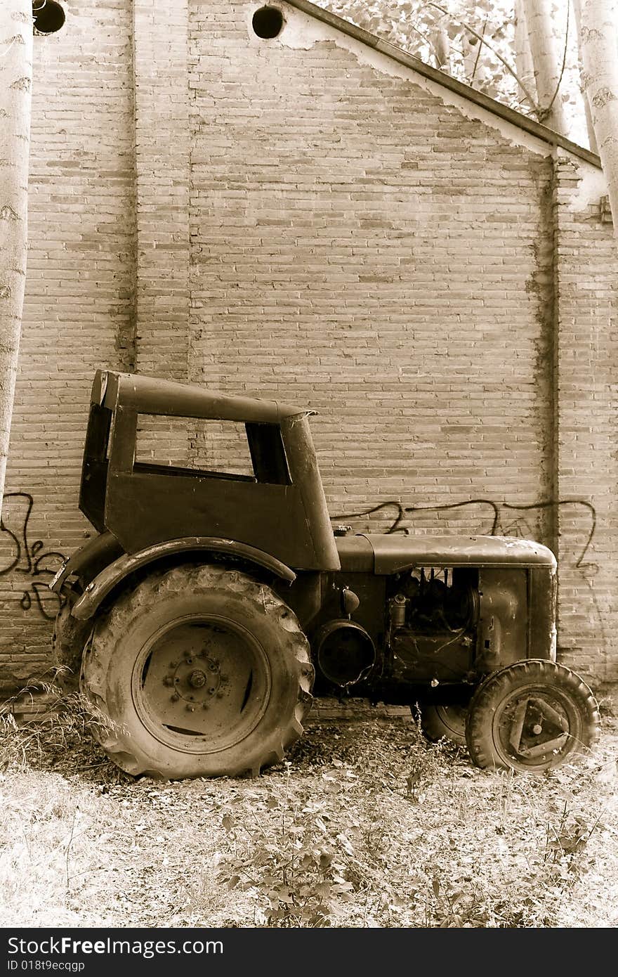 Abandoned tractor close to an old building. Abandoned tractor close to an old building.