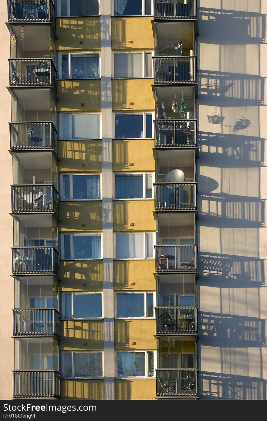 Balconies casting a shadow on the wall.