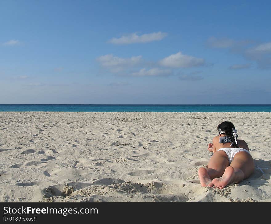 Female in a white bikini on the beach