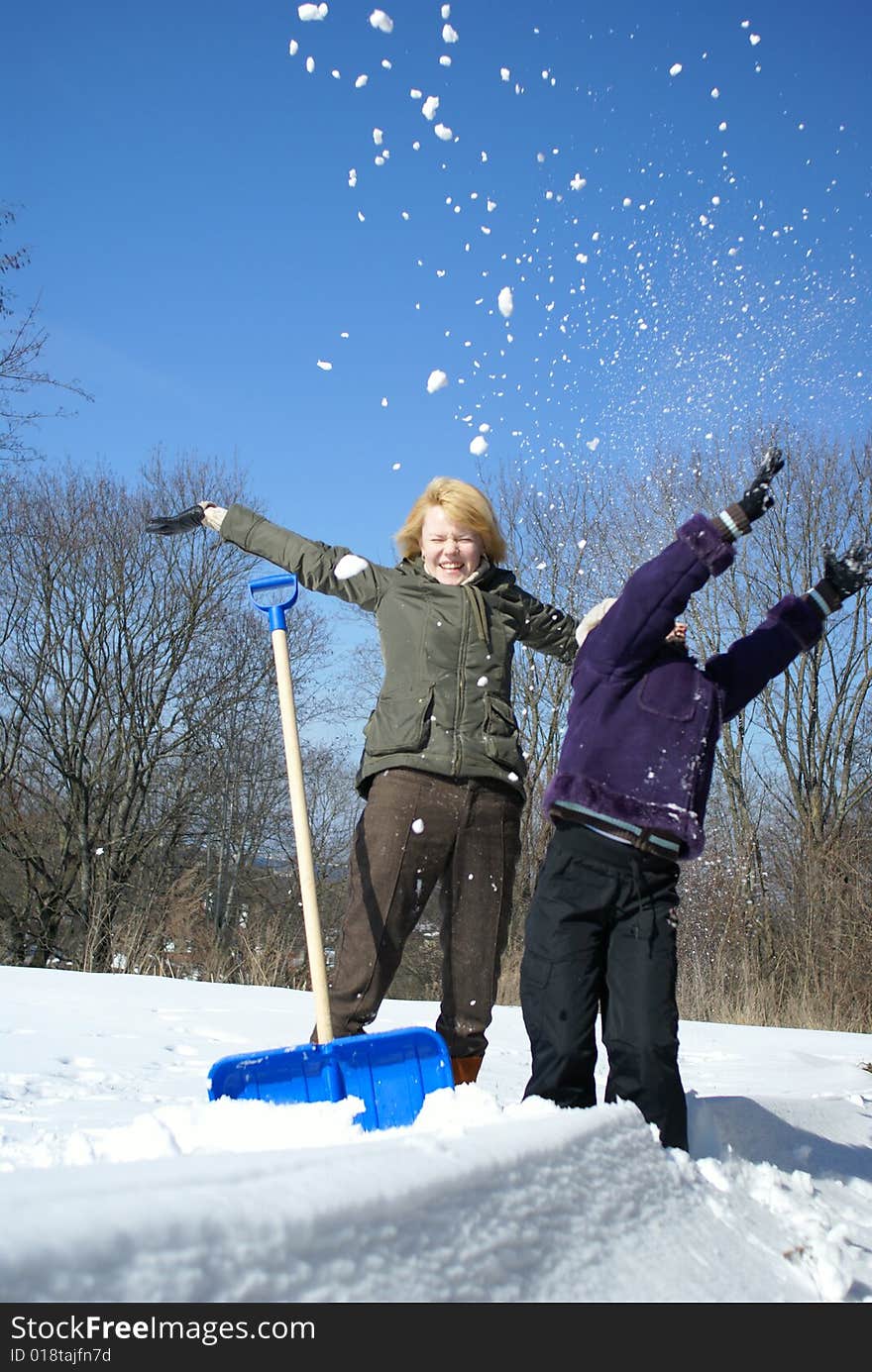 Mother And Her Daughter On A Winter Background