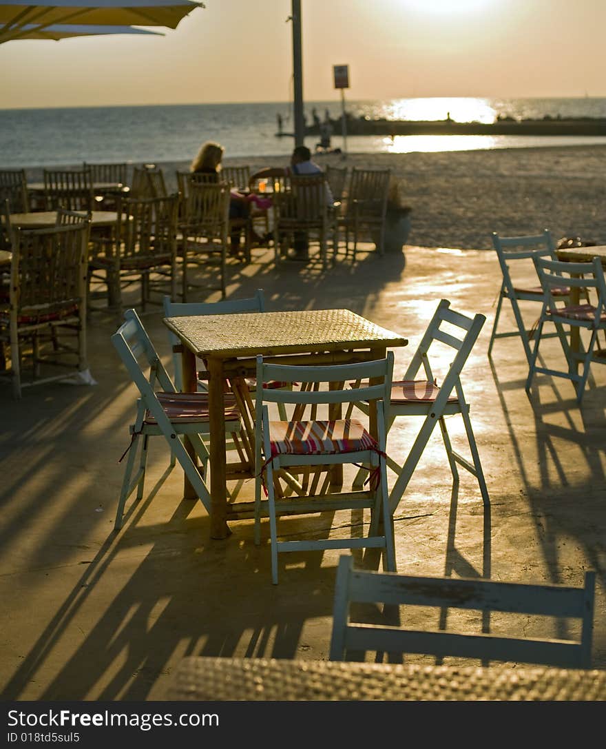 Empty table at a restaurent on a beach in the sunset. Empty table at a restaurent on a beach in the sunset