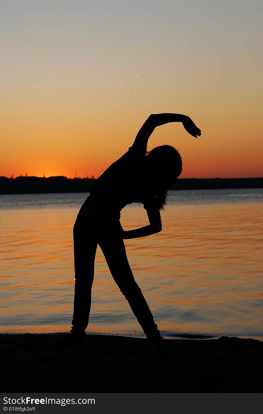 Girl doing exercises on the beach. Girl doing exercises on the beach