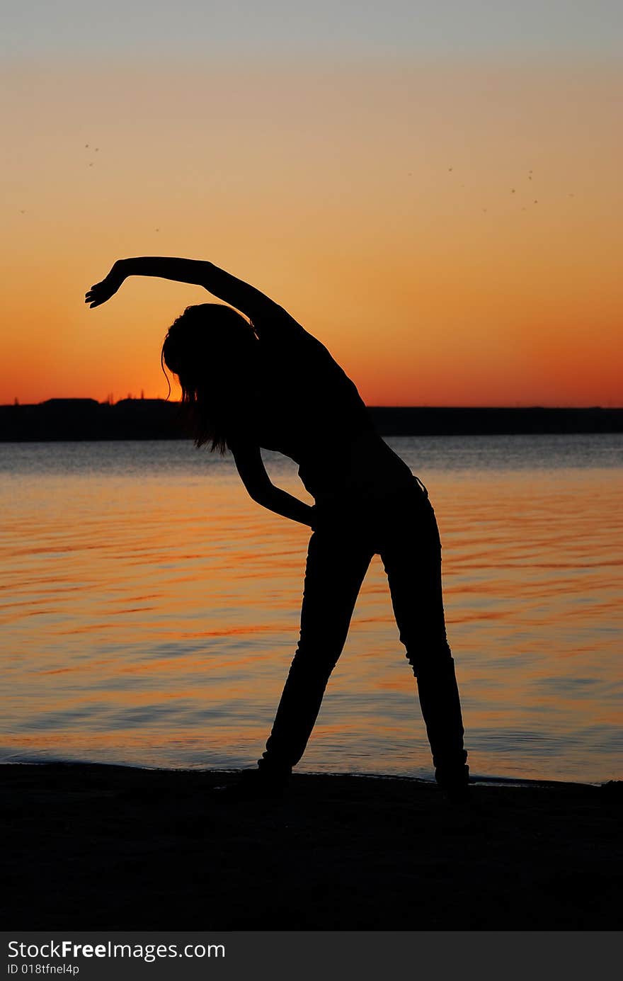 Girl doing exercises on the beach. Girl doing exercises on the beach