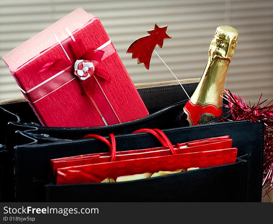 Leather case with red gift and bottle of wine. Leather case with red gift and bottle of wine