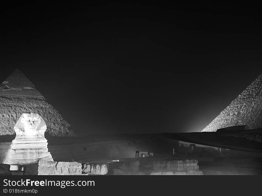 The ancient pyramids of Egypt, in Cairo, at night.