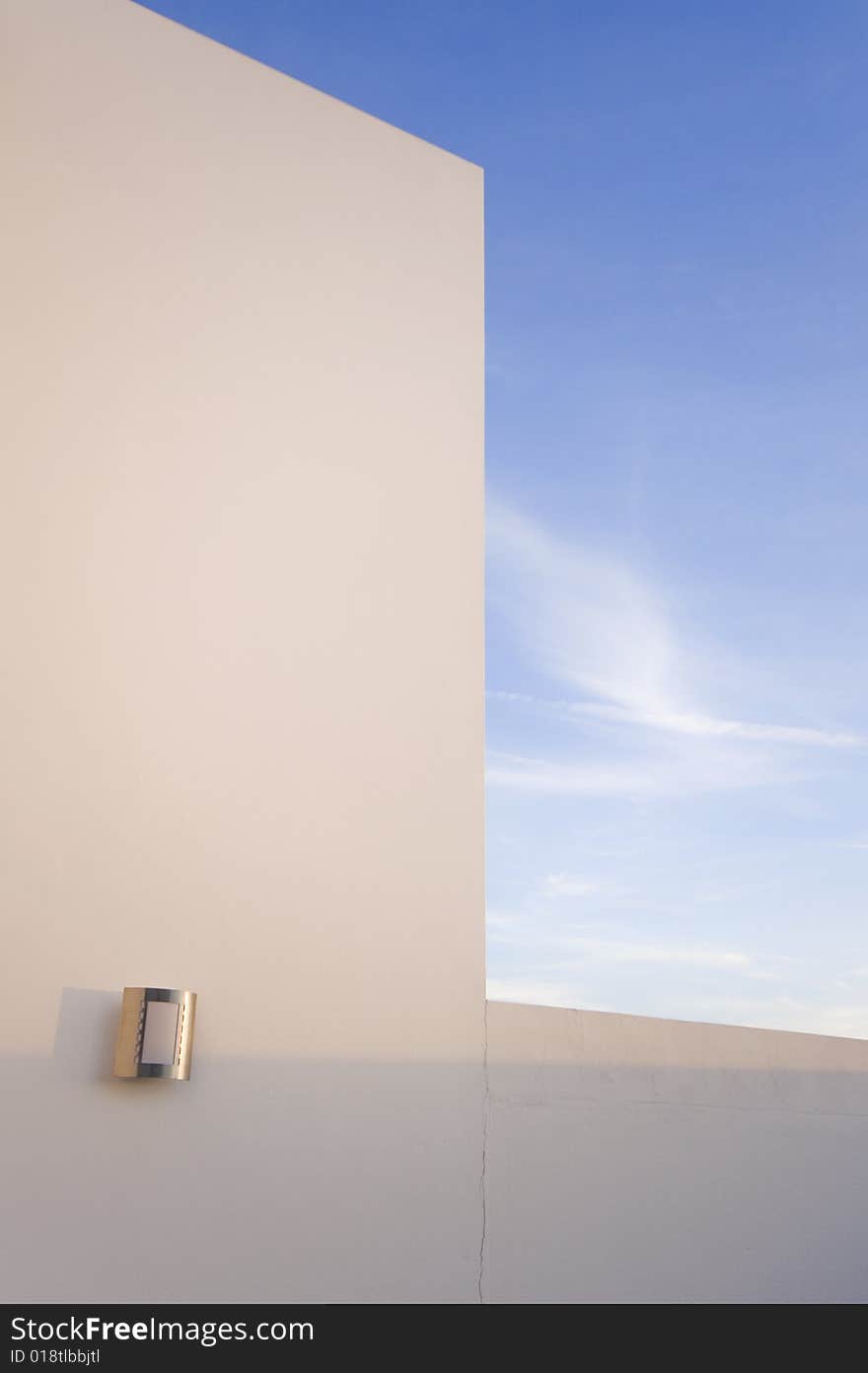 Detail of the facade of a modern house with a blue sky. Detail of the facade of a modern house with a blue sky