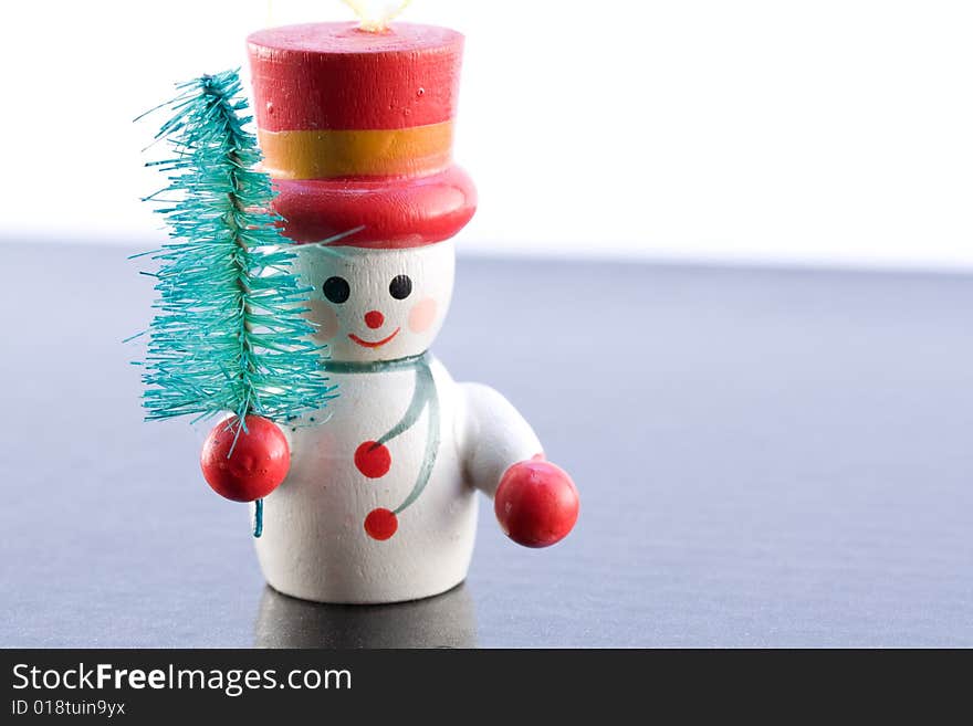 A Snowman carrying a tree on icey background. A Snowman carrying a tree on icey background.