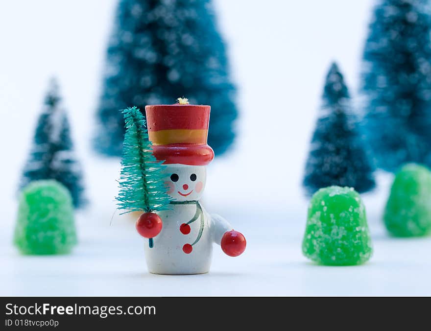 Snowman in Snow with Trees and Gumdrops in Background. Snowman in Snow with Trees and Gumdrops in Background