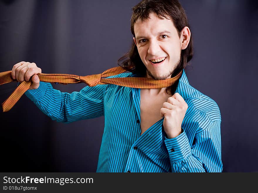 Man in blue shirt and tie on black