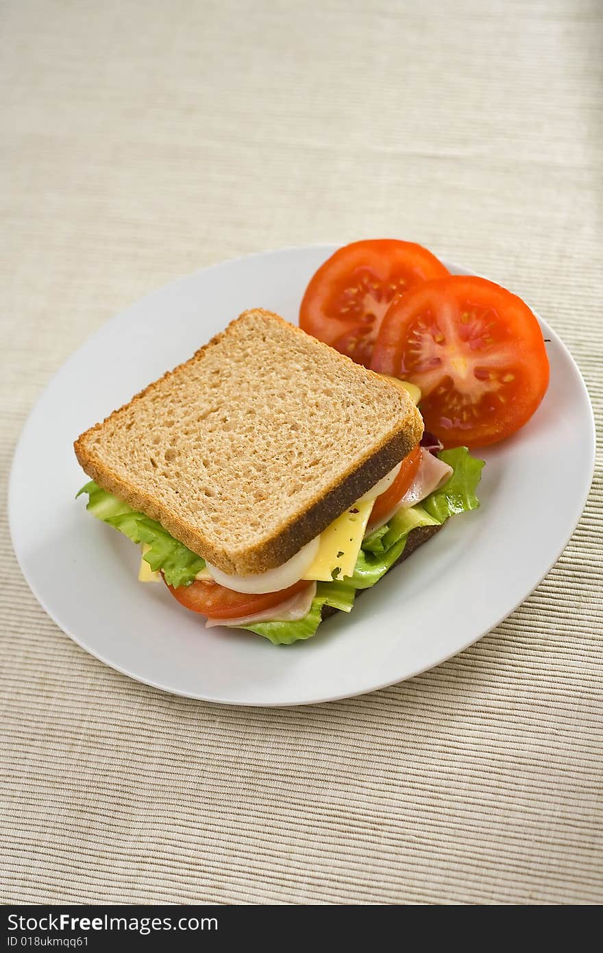 A delicious and healthy sandwich turkey ham cheese lettuce tomato and onion