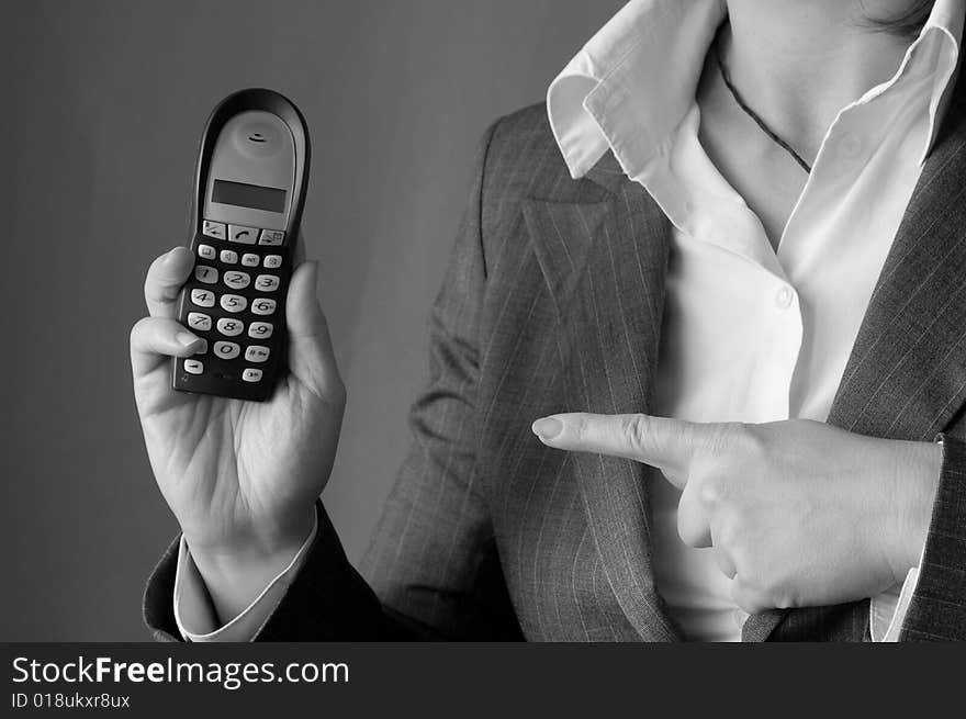 The young businesswoman hold the phone in the hand