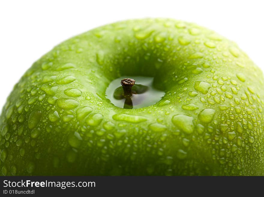 Fresh green apple with water droplets isolated