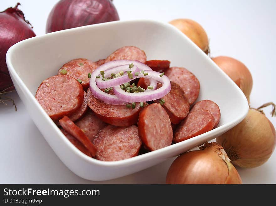 Fresh italian cabanossi with onions in a bowl