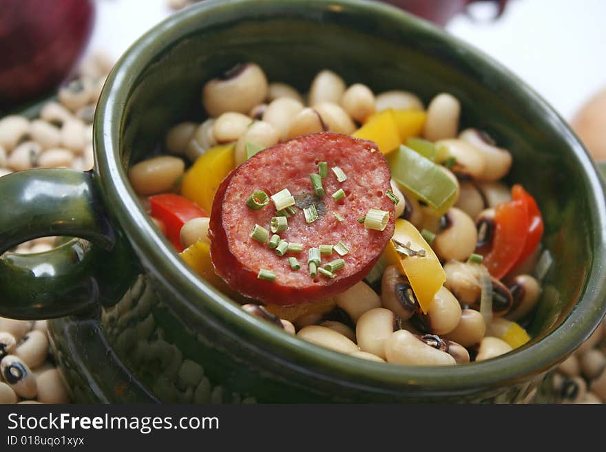 A stew of fresh beans, vegetables and sausages. A stew of fresh beans, vegetables and sausages