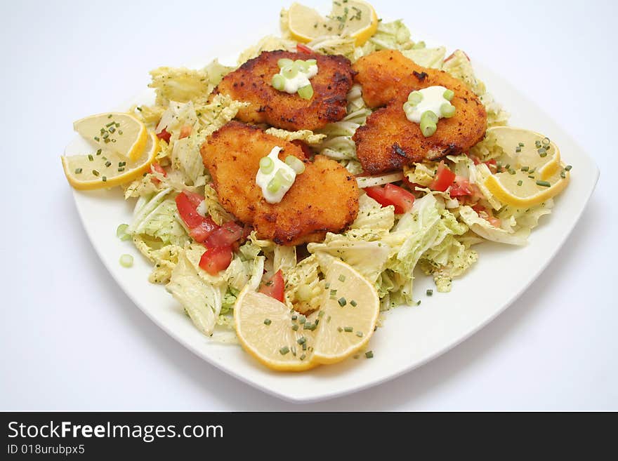 A meal of salad and meat on a plate