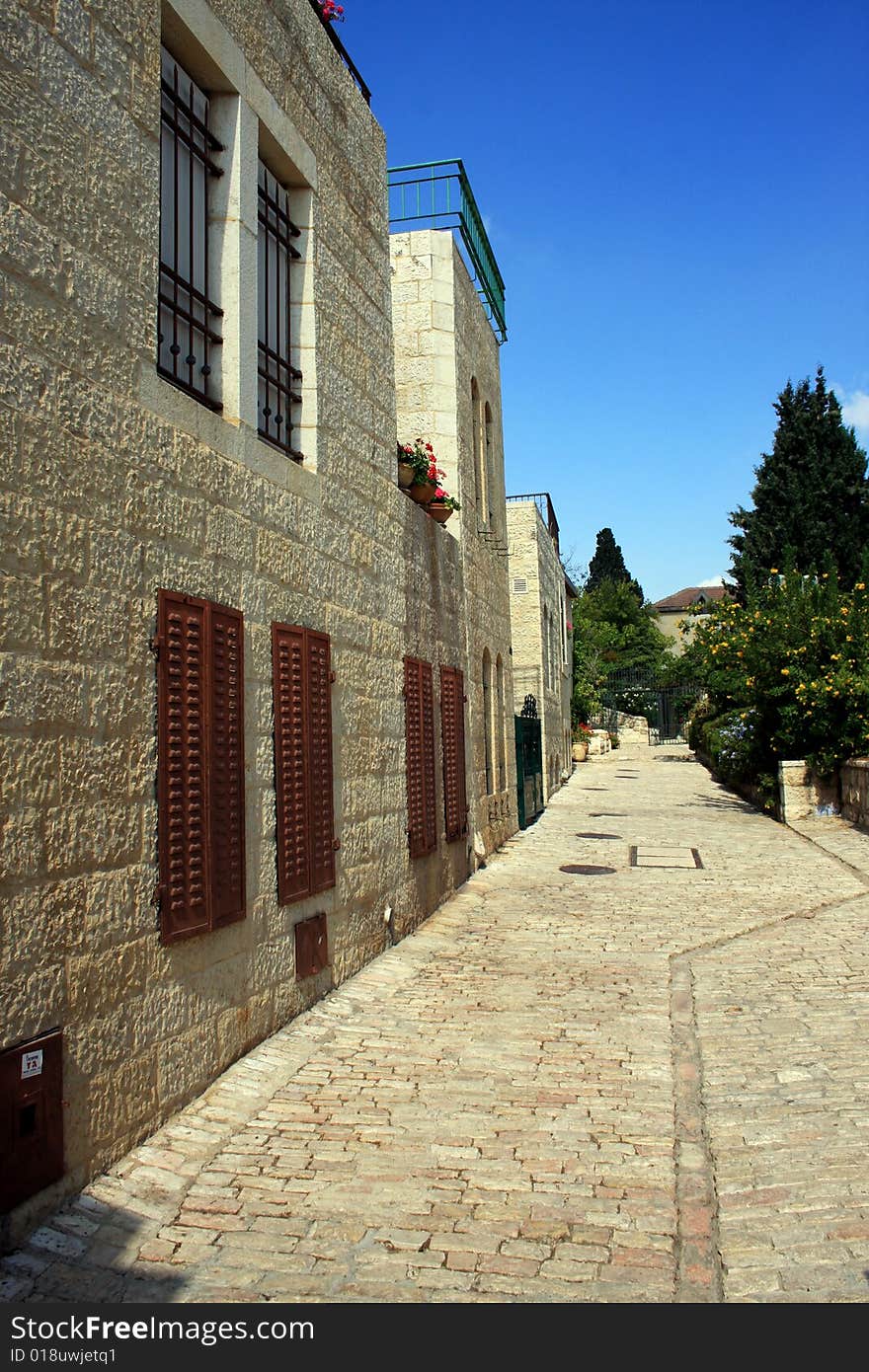 Cobblestone path alongside a row of historic houses in Yemin Moshe, Jerusalem. Cobblestone path alongside a row of historic houses in Yemin Moshe, Jerusalem